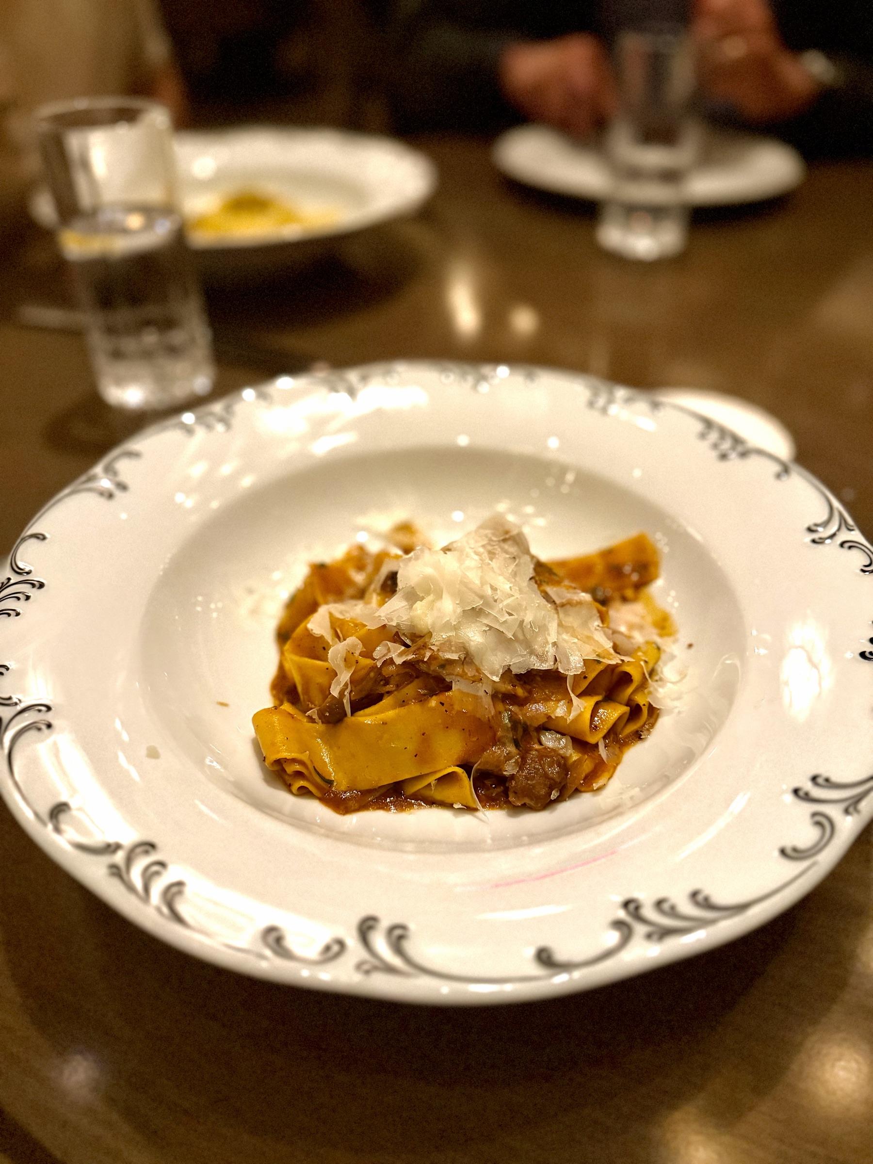 Pappardelle with shaved parmesan on a vintage plate.